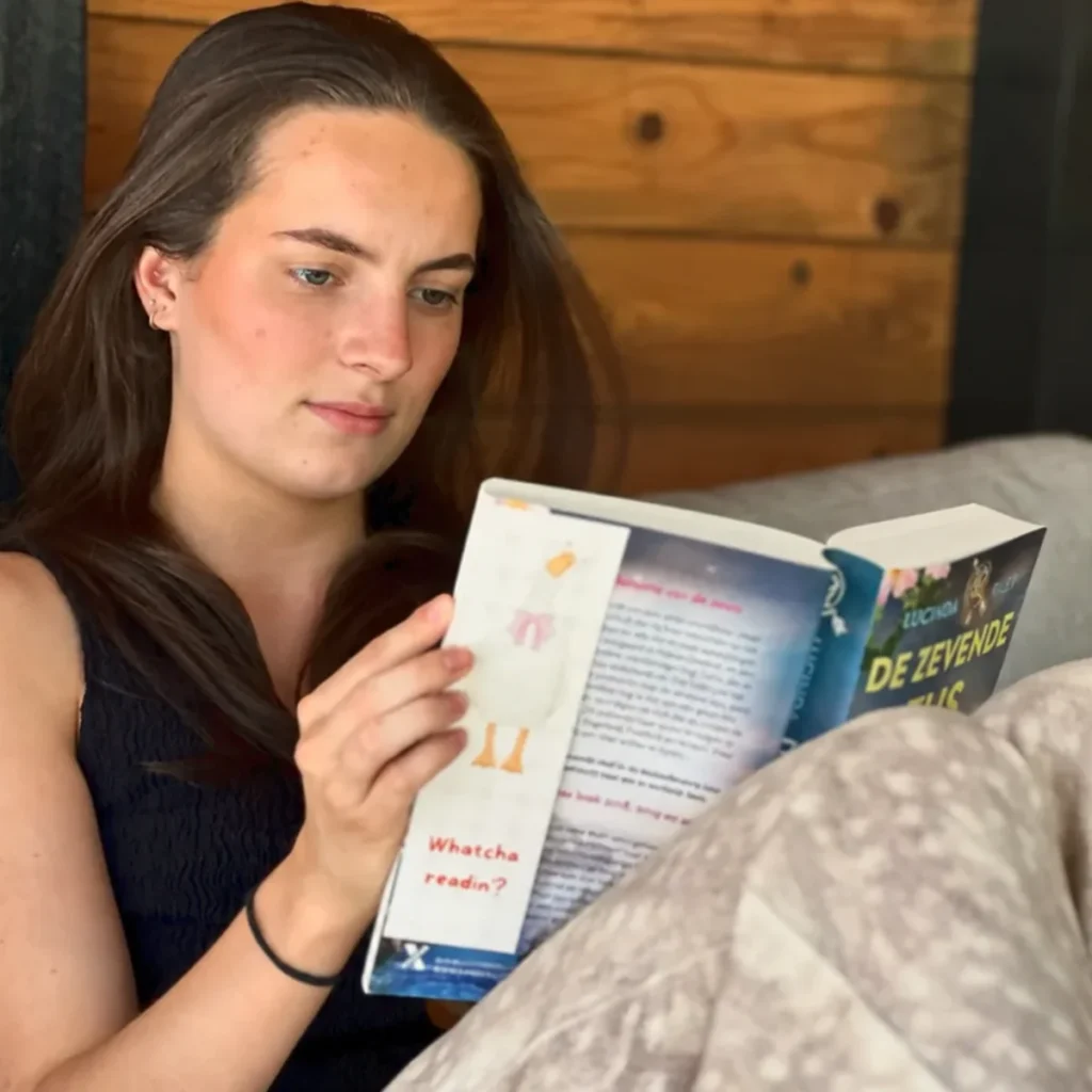 Manouk leest met een ReadMark uit de collectie Paws & Pages in haar boek